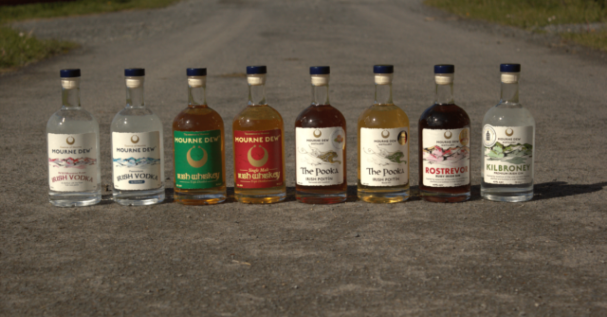 Bottles of Mourne Dew Distillery lined u on a mountain road