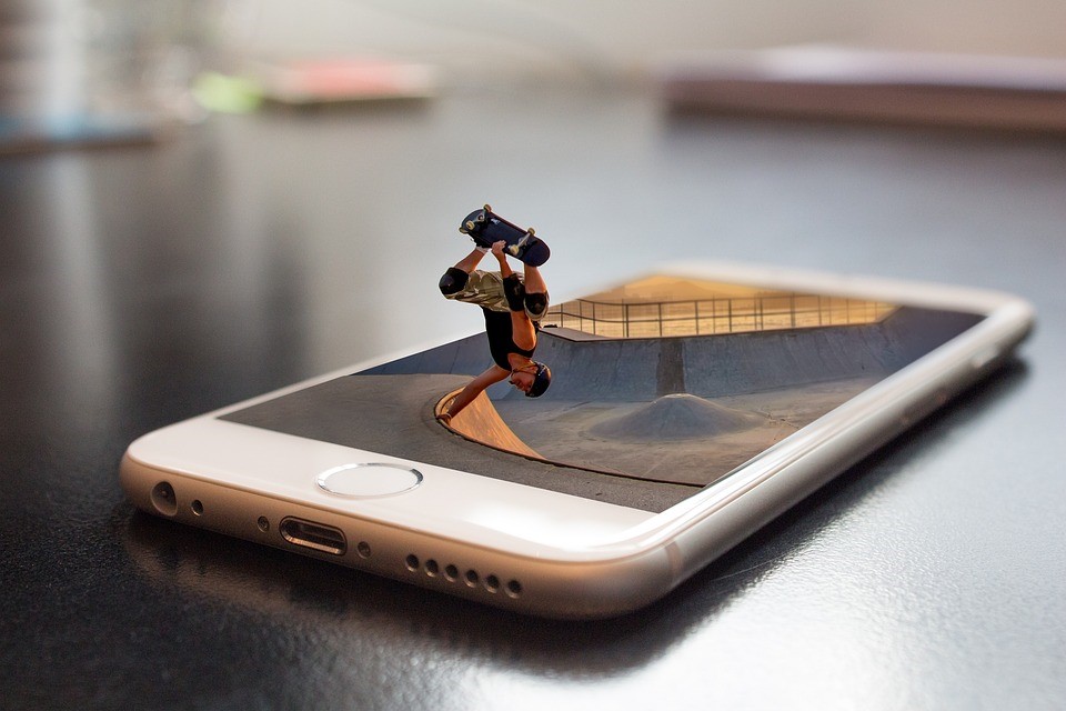 Picture of a man skateboarding on a phone screen.
