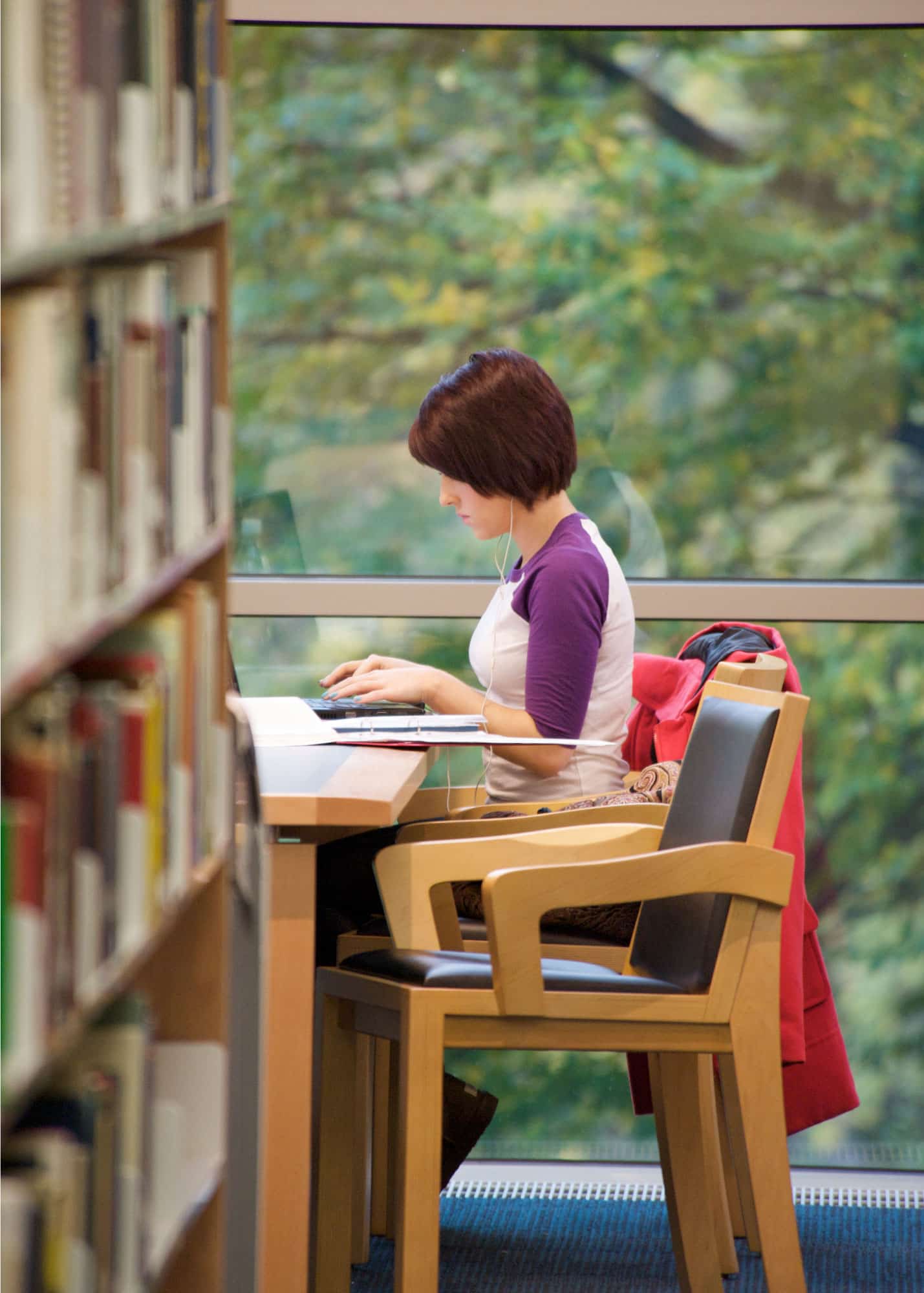 A young woman studying in a library