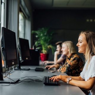Student working on desktop computers in a computer lab