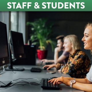 Student working on desktop computers in a computer lab