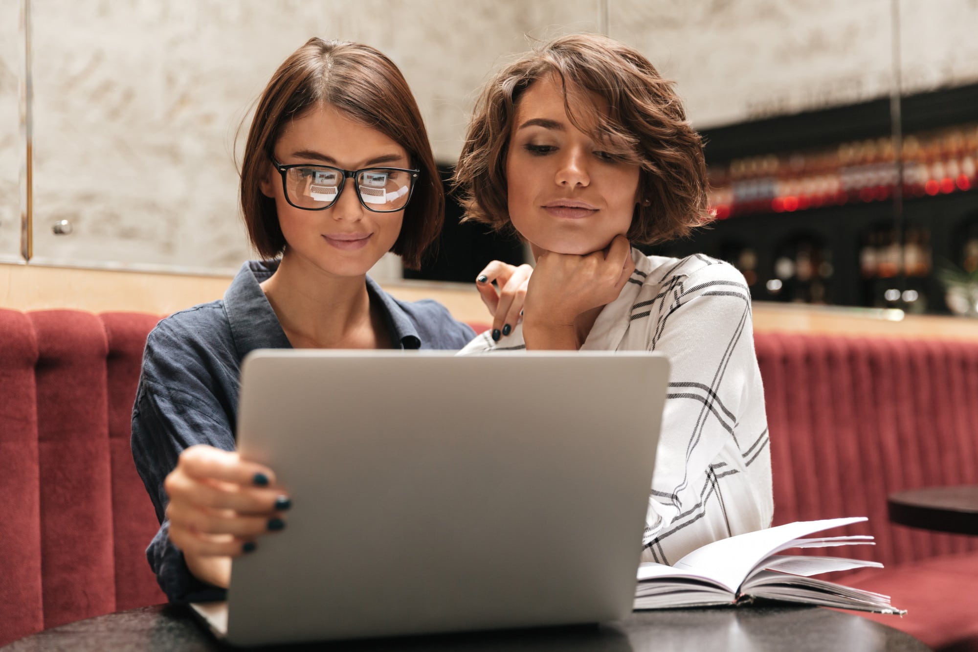 Two young women looking at a laptop