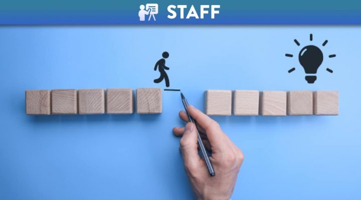 Hand drawn person jumping a gap to reach the goal