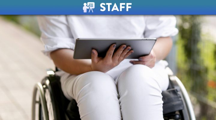 Woman using a tablet on a wheelchair