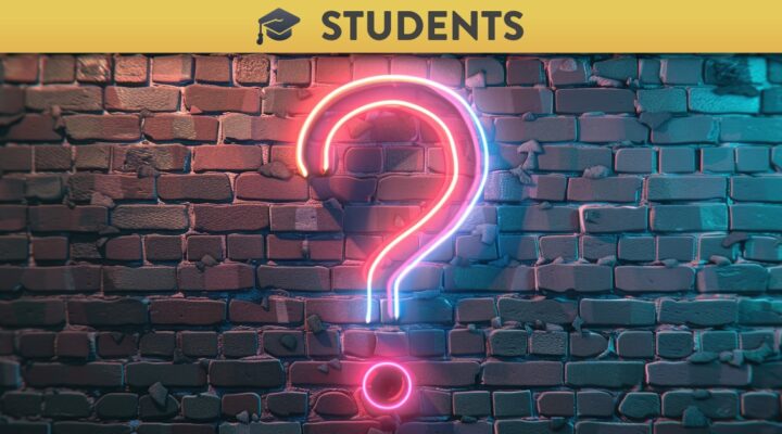 Neon question mark on brick wall