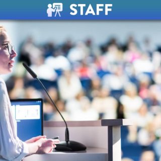 Female academic teaching class in lecture theatre