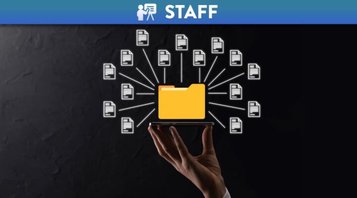 Hand holding a phone with a projection of files and a folder