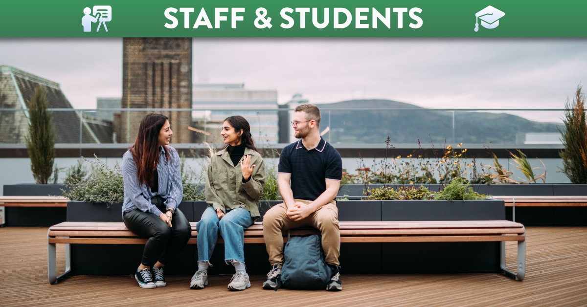 Two female and one male student sitting on a bench at QUB One Elmwood