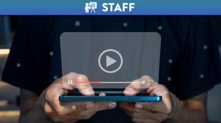 Person using a phone to watch a video