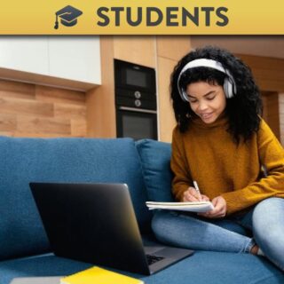 Student watching lecture recording and taking notes