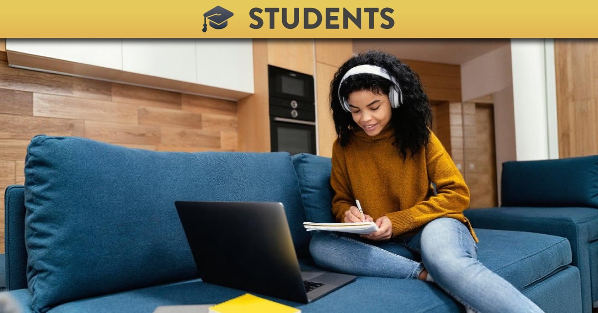 Student watching lecture recording and taking notes