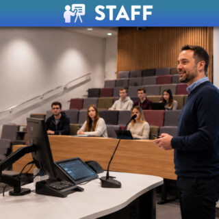 Academic in lecture theatre teaching students