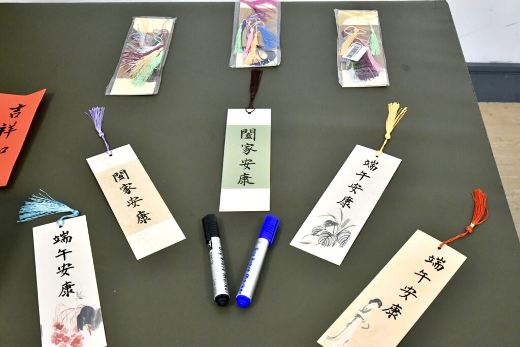 Workshop tables set with calligraphy bookmarks.