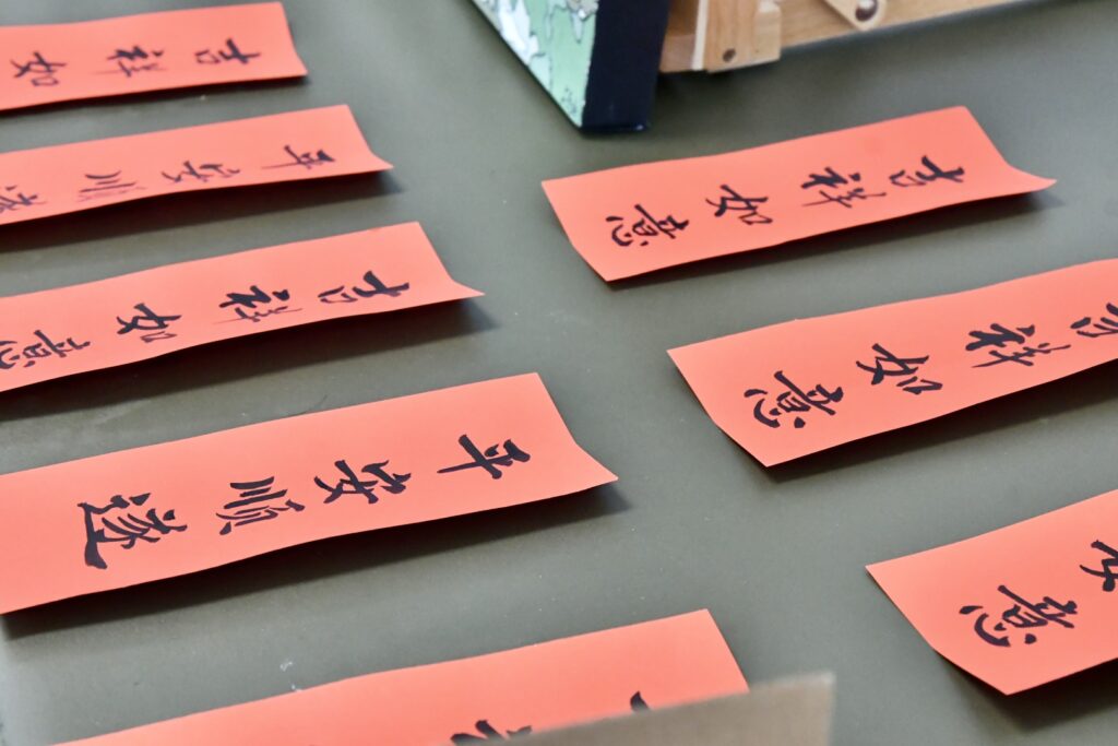Workshop tables set with calligraphy bookmarks.