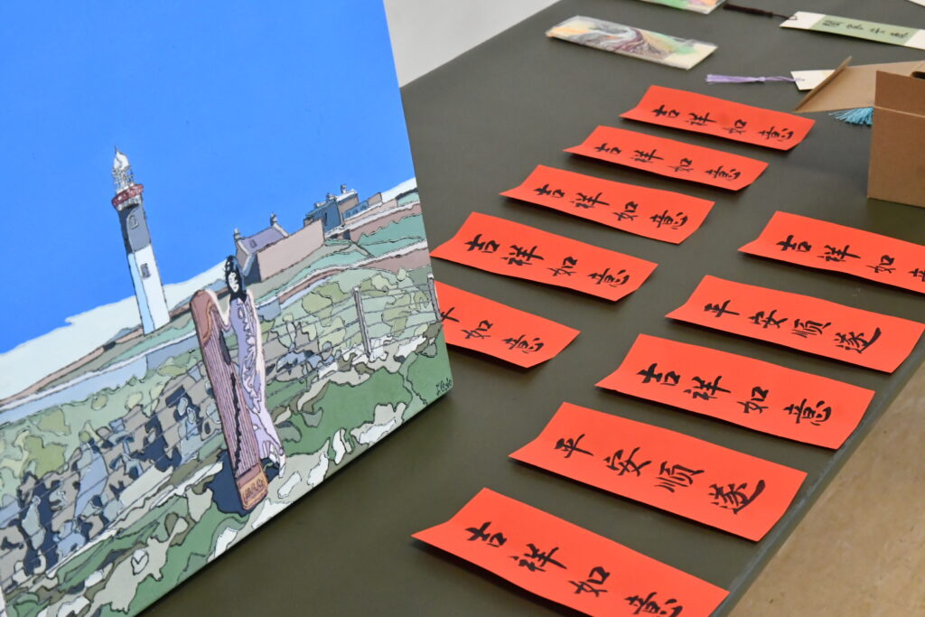 Workshop tables set with calligraphy bookmarks.