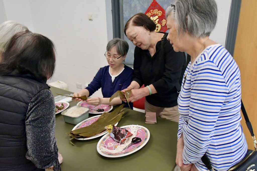 Zongzi master deomstrating zongzi wrapping up techniques.