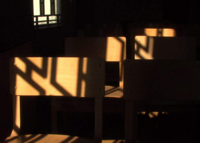 Chapel chairs hit with window light