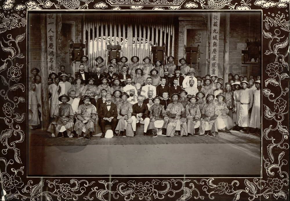 Photograph taken in Wuchang of a large group of British and Chinese men which includes the Viceroy and Governor, 30 July 1902. The photograph is annotated, 'Viceroy and Governor second row [from the back in the middle of the row sitting next to each other] sitting with Consular Body on right and left'. Reference: MS 15.6.3.023 QUB Special Collections and Archives