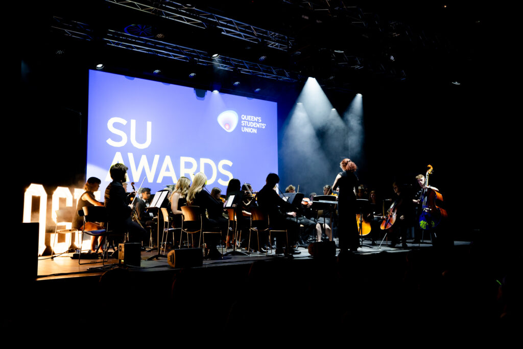 Queen's University Symphony Orchestra performing on stage