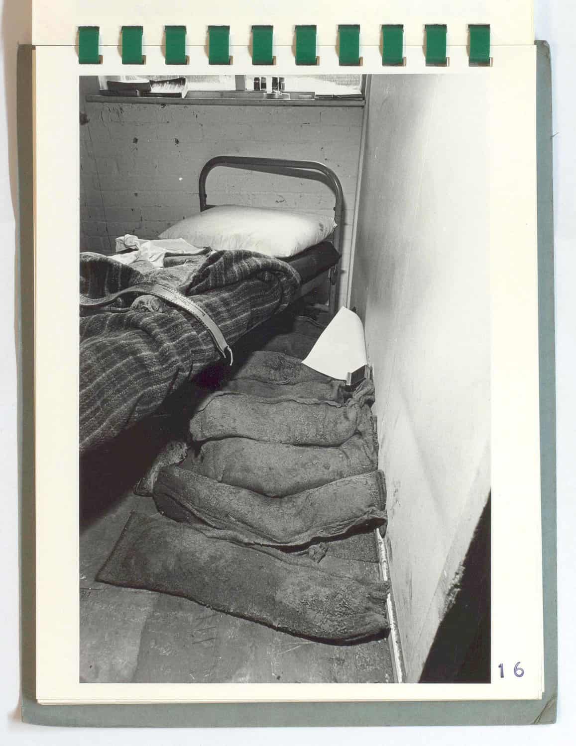 a bed pulled away with sandbags on the floor. a bed pulled away with sandbags on the floor.