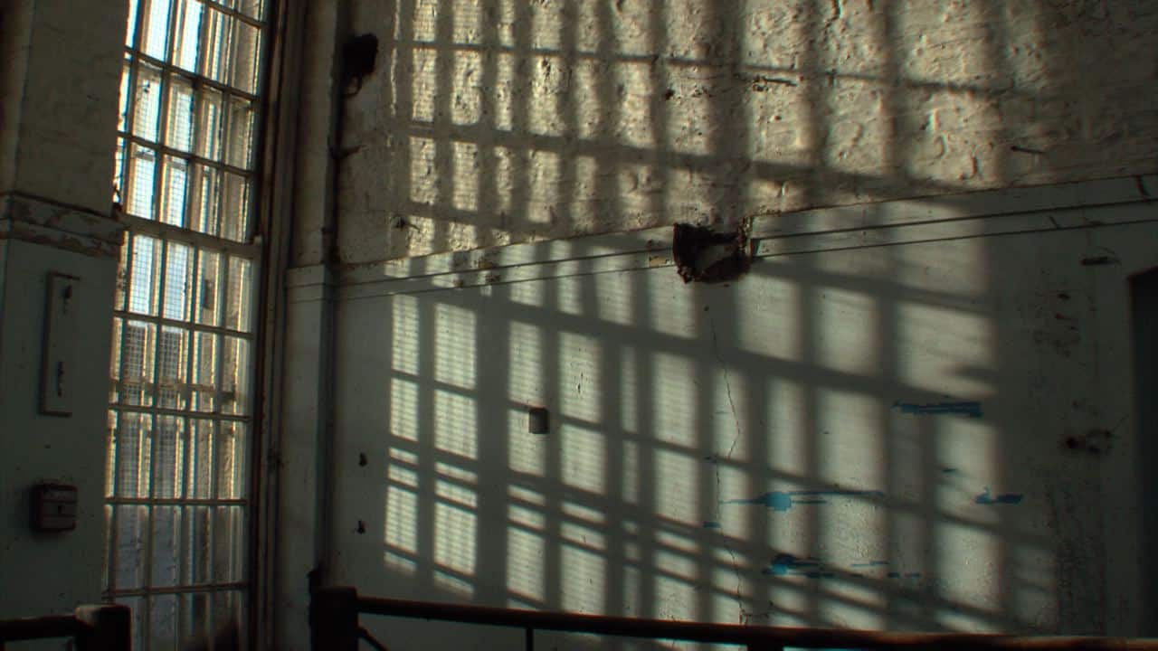 window grid throwing shade on the prison wall. window grid throwing shade on the prison wall.